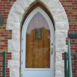 Arched door - full length window, stone trim