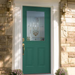 Green door, inlaid frosted window design, white column trim